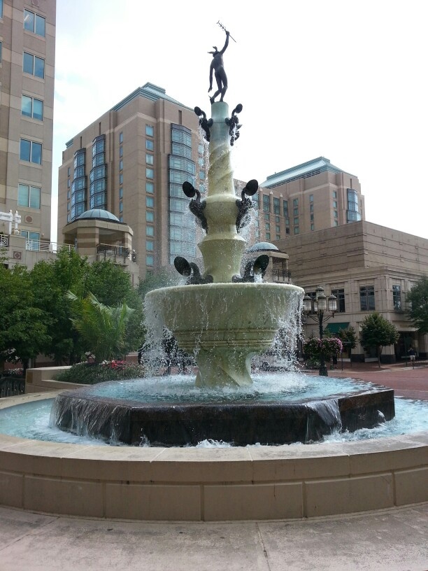 a fountain in the middle of a city square