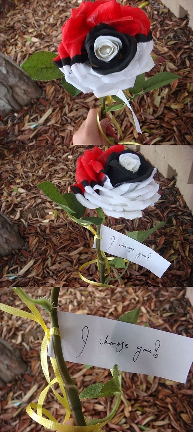 a hand holding a fake flower with a note attached to it