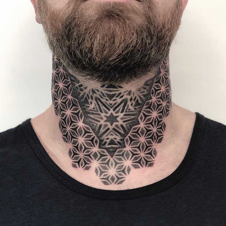 a man with a neck tattoo that has geometric designs on his face and neck area