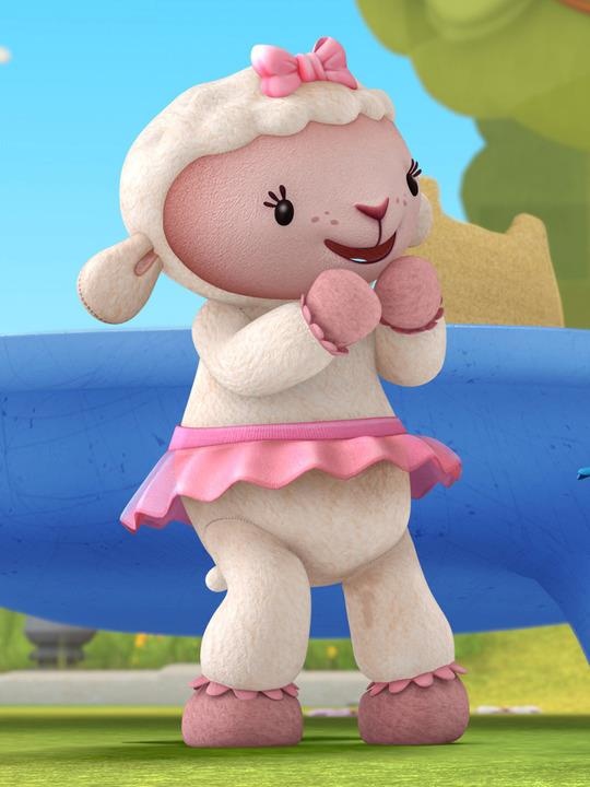 a cartoon sheep in a pink dress standing next to a blue object with trees in the background