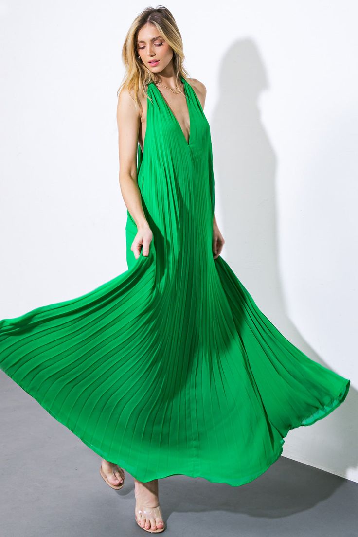 An exquisite woven maxi dress with a V halter neckline, delicate pleating, and a bare back secured by a neck tie.Details:Self : 100% PolyesterLining : 100% PolyesterSize & Fit- Model is 5`8" And Wearing Size Small- Measurements Taken From Size Small- Approx. Length: 62" Green Maxi Length Halter Dress For Evening, Chic Green Halter Dress For Evening, Green Maxi Length Halter Dress For Party, Green Maxi Halter Dress For Evening, Elegant Green Maxi Dress With Pleated Back, Green Halter Maxi Dress For Evening, Chic Green Backless Maxi Dress, Green Floor-length Halter Dress For Party, Elegant Green Halter Neck Maxi Dress