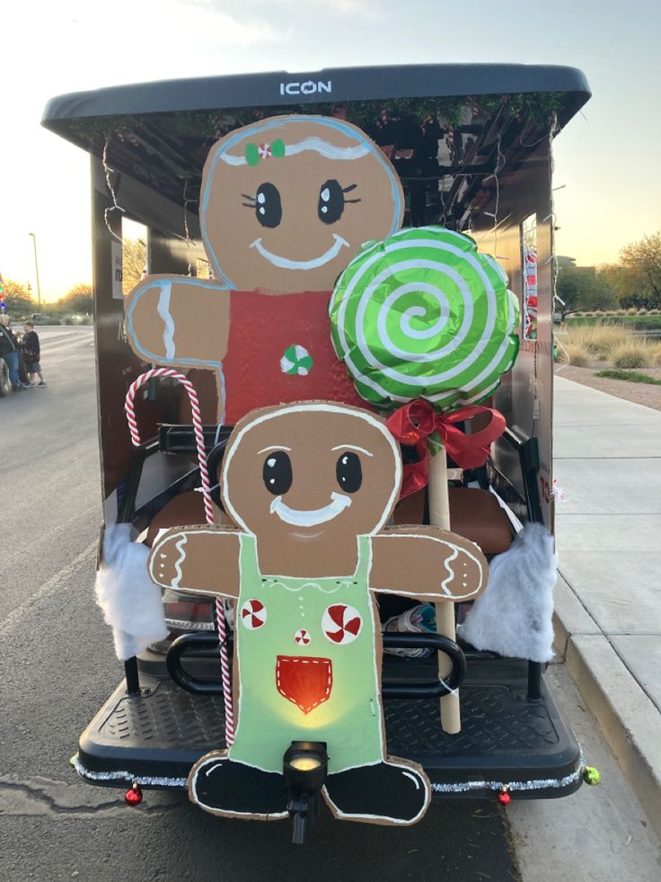 a golf cart decorated with gingerbread man and candy canes