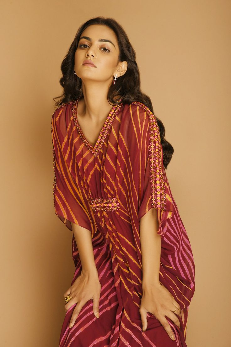 Wine kaftan with all-over chevron print and V-neck.
Component: 1
Printed, Embellished
Neckline: V-Neck
Sleeve Length: Three Quarter
Fabric: Georgette
Color: Maroon
Embellishments at the neckline, sleeves and waist
Note: Inner slip worn by the model is not for sale - Aza Fashions Kaftan Women, Kaftan For Women, Printed Kaftan, Embellished Neckline, Fashion App, Chevron Print, Not For Sale, Aza Fashion, Three Quarter