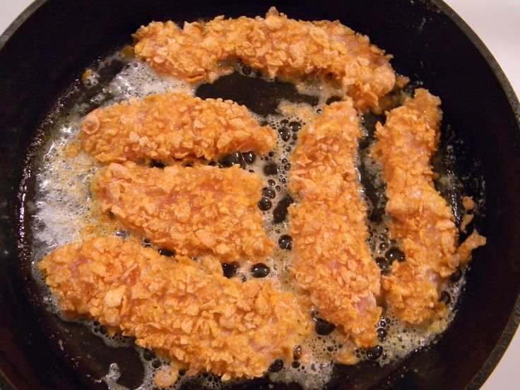 fried chicken is cooking in a frying pan