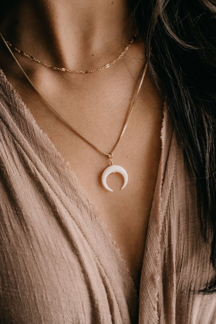 A stunning fresh water mother of pearl double horn crescent necklace measuring approximately 3/4". Each crescent is unique as these are hand carved and wire wrapped in your choice of metal! •D E T A I L S• -Available in 14k gold filled or sterling silver -Chain length 16", 18", 20", 24" -Box chain and spring clasp included GIVING THIS AS A GIFT? Your jewelry will arrive to you in one of our beautifully branded Mountain Feather gift boxes, perfect for gift giving! I provide one gift box for every Bohemian White Crescent Jewelry, White Crescent Bohemian Jewelry, Gold Moon-shaped Wire Wrapped Jewelry, Gold Crescent Wire Wrapped Jewelry, White Crescent Spiritual Jewelry, White Crescent Handmade Necklace, Handmade White Crescent Necklace, Delicate Crescent Moon Phase Jewelry, Gold Crescent Wire Wrapped Necklaces