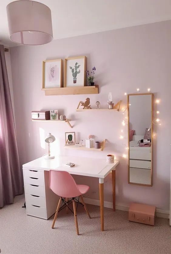 a bedroom with a desk, mirror and lights on the wall in it's corner