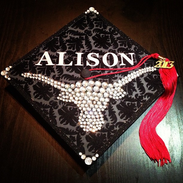 a black and white graduation cap with red tassels on it that says, alson