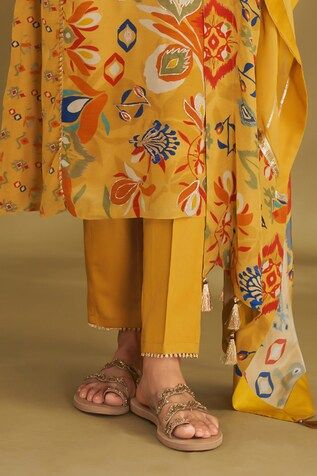 Dandelion yellow A-line kurta with ikat, floral print and gold embroidery in center panel. Paired with narrow pant and gota embroidered dupatta. - Aza Fashions Yellow Floral Print Kurta, Yellow Floral Print Kurta For Wedding, Designer Yellow Kurta With Printed Motifs, Designer Wear Yellow Kurta With Printed Motifs, Yellow Floral Print Sets For Designer Wear, Mustard Color Straight Kurta Set, Mustard Straight Kurta Sets, Yellow Silk Sets With Printed Motifs, Yellow Resham Embroidery Sets