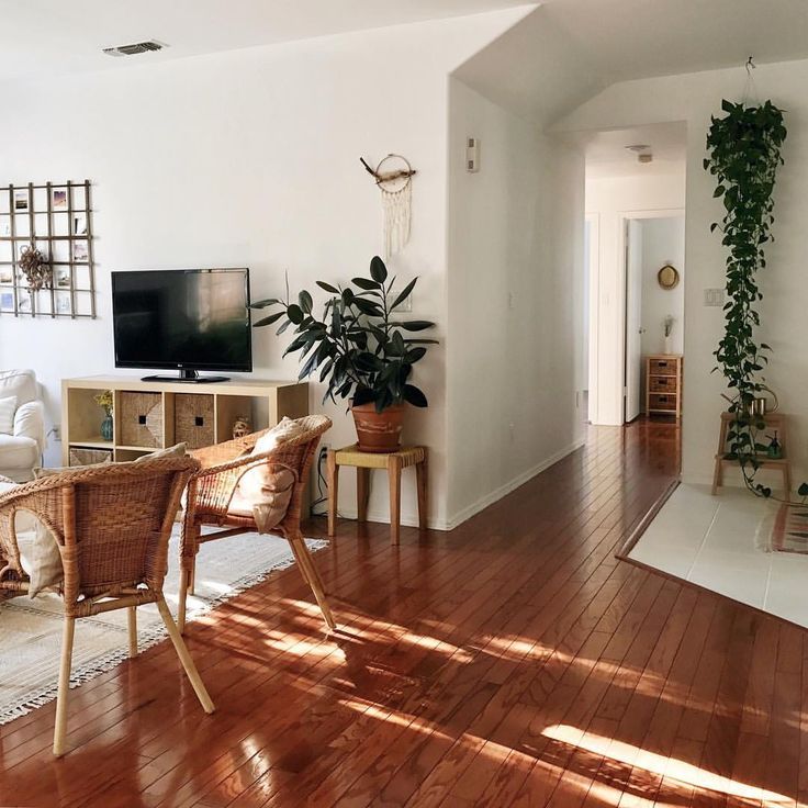 a living room filled with furniture and a flat screen tv on top of a wooden table