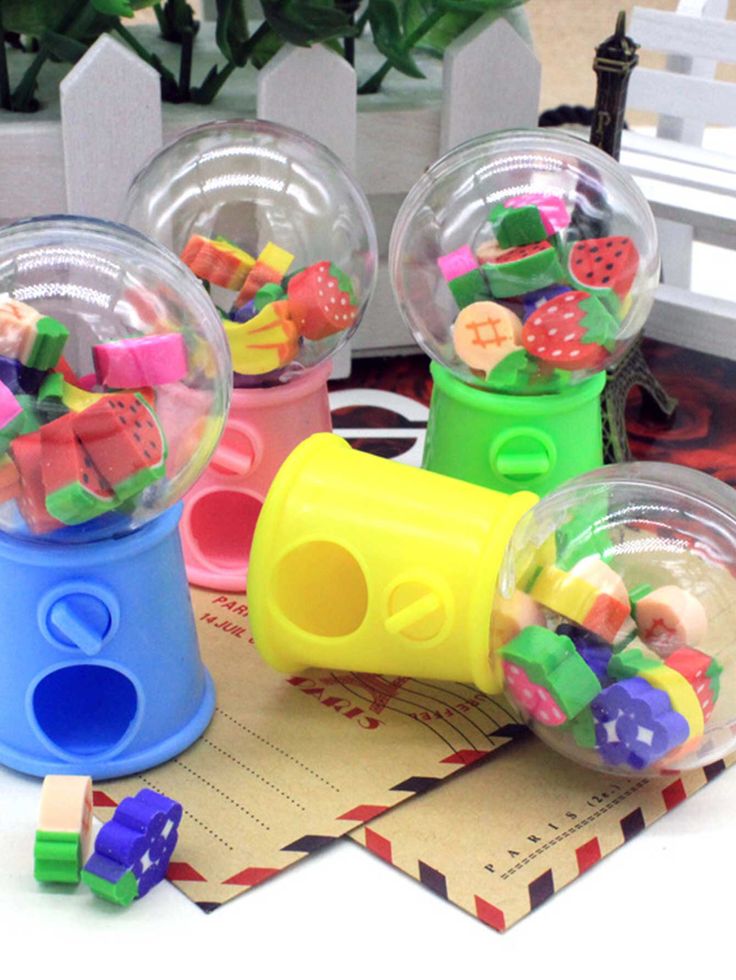 four plastic toys are sitting on top of a table