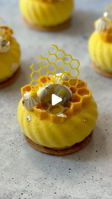 some yellow cupcakes with honeycomb decorations on them