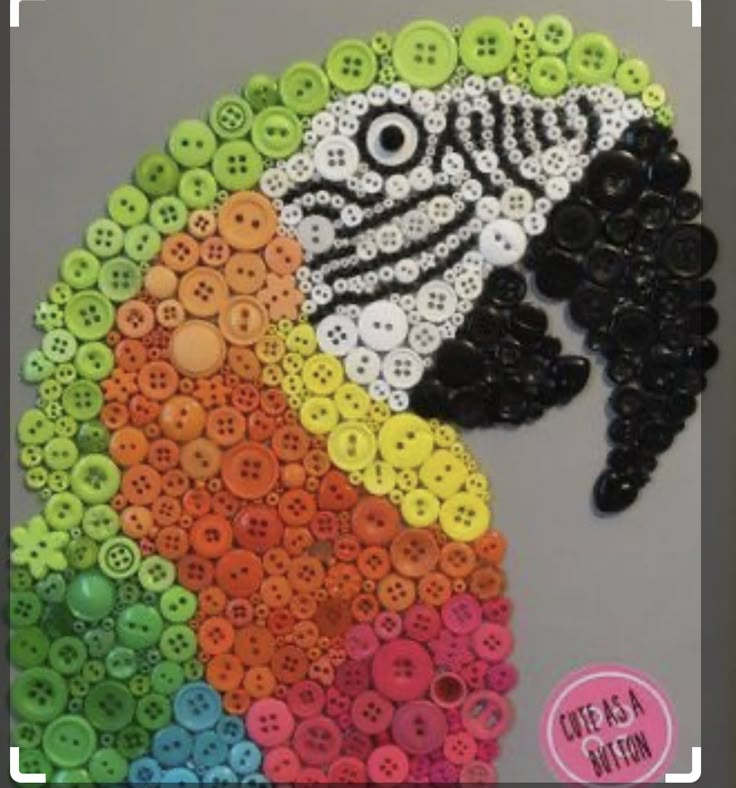 the button art is made with buttons and plastic beads to look like a woman's head