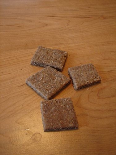 four crackers sitting on top of a wooden table