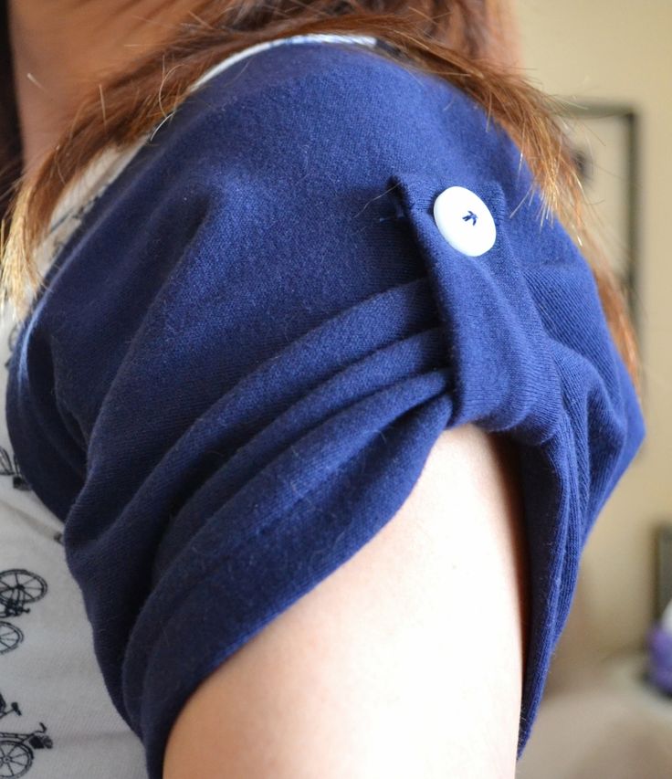 a close up of a person wearing a blue shirt with an eye patch on it