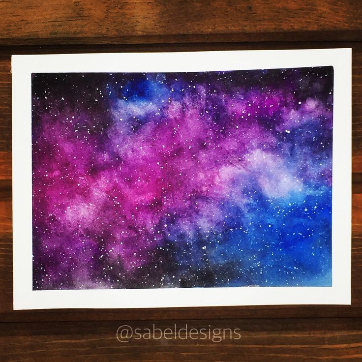 a painting of the night sky with purple and blue stars in it on a wooden surface