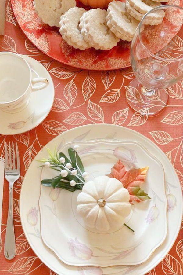 a table topped with plates and cups filled with food