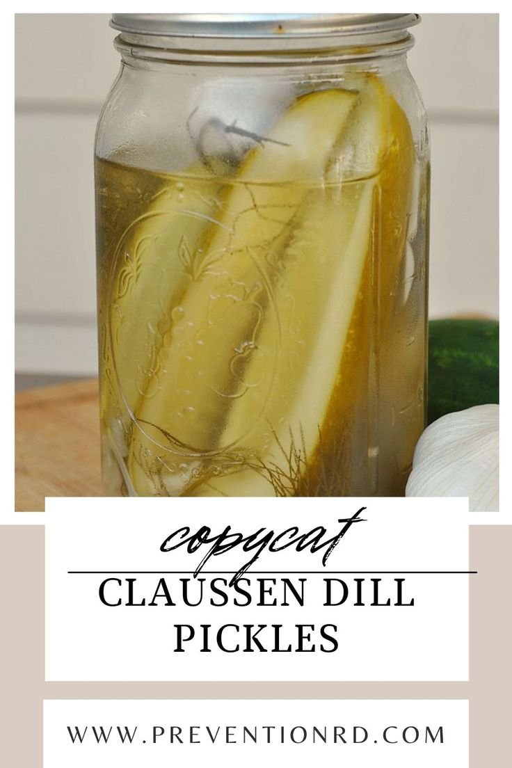 a mason jar filled with cucumber, lemon and dill pickles