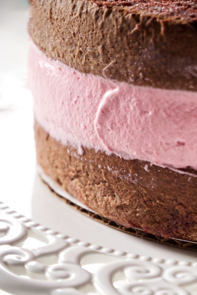 a close up of a cake with pink frosting on it's top and bottom