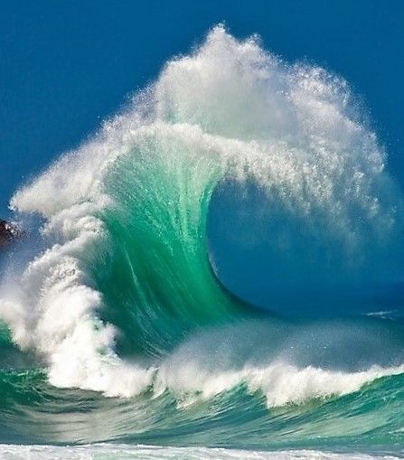 a man riding a wave on top of a surfboard