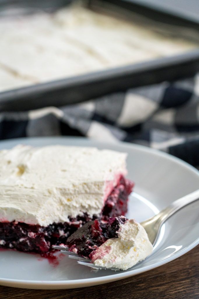 a piece of cake on a white plate with a fork in front of the rest