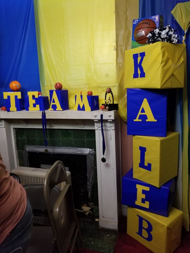 a room with blue and yellow decorations on the walls, including blocks that spell out team name