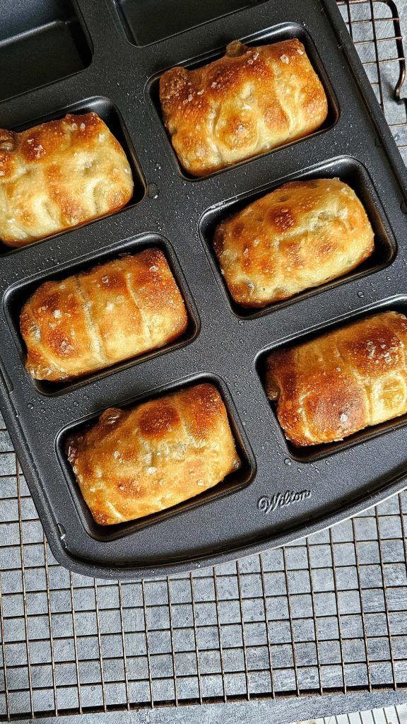 six pastries in a muffin pan on a cooling rack