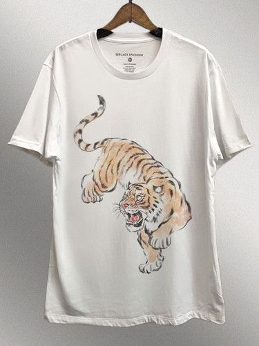 Graphic of a tiger on a white short sleeve tee. Casual White Printed T-shirt, White Printed Casual T-shirt, White Shirt With Sublimation Print And Relaxed Fit, White Printed Graphic Tee Shirt, White Shirt With Sublimation Print Relaxed Fit, Relaxed Fit Shirt With White Graphic Print, White Graphic Print Shirt With Relaxed Fit, White Graphic Tee In Relaxed Fit, White Graphic Tee Relaxed Fit