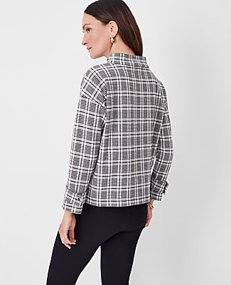 Elevate your wardrobe with the Ann Taylor Petite Plaid Button Tab Mock Neck Top, a perfect blend of style and comfort. This top is designed specifically for petite frames, ensuring a flattering fit for smaller proportions.

- **Size:** Petite 2XS
- **Color:** Black
- **Material:** 62% Cotton, 37% Polyester, 1% Spandex
- **Gender:** Female
- **Fit:** Relaxed
- **Length:** 22 3/4" long
- **Sleeve Type:** Long sleeves with button tab cuffs
- **Neckline:** Mock neck
- **Care Instructions:** Machine Classic Long Sleeve Mock Neck Top For Work, Casual Mock Neck Top For Spring Workwear, Spring Casual Mock Neck Top For Work, Casual Mock Neck Top For Work In Spring, Casual Spring Mock Neck Top For Work, Casual Mock Neck Top For Work, Versatile Long Sleeve Mock Neck Top For Work, Casual Tops With Stand Collar And Button Cuffs, Winter Workwear Top With Stand Collar