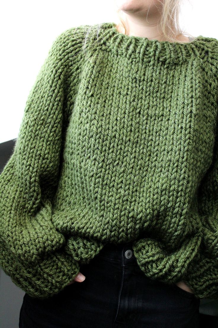 a woman wearing a green knitted sweater