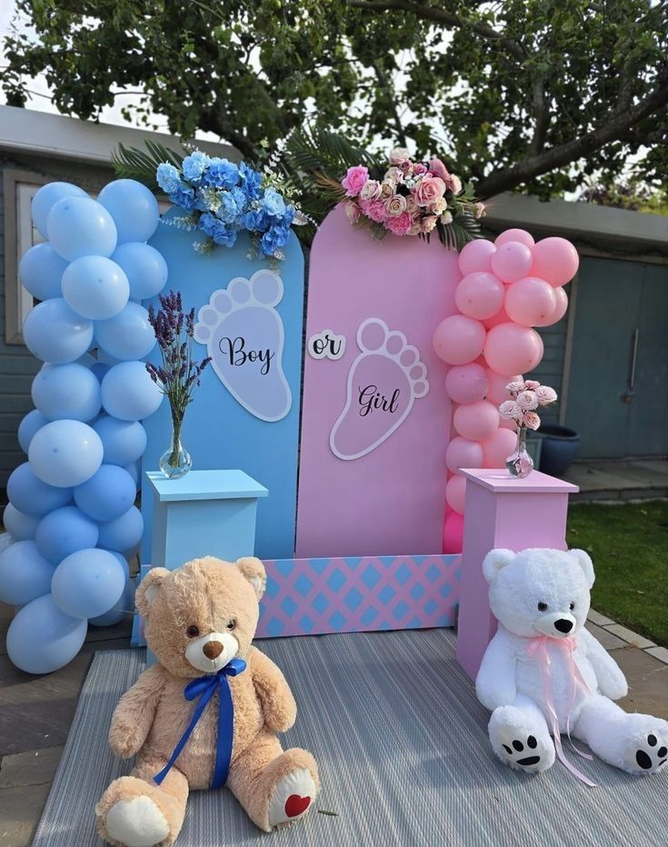 two teddy bears are sitting on the ground next to balloons and vases with flowers