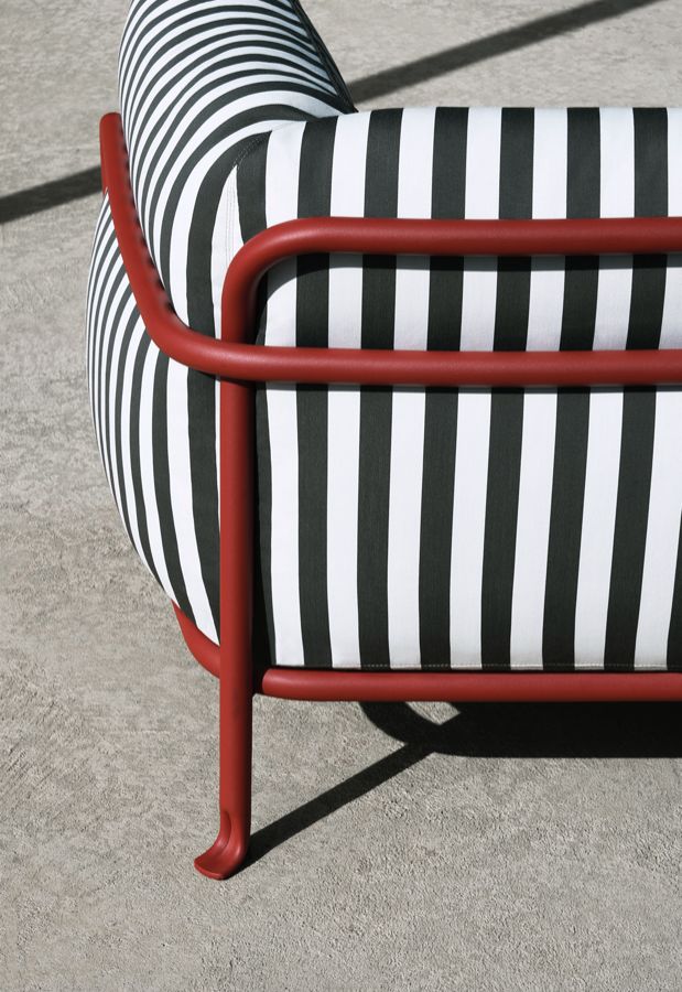 a black and white striped chair sitting on concrete