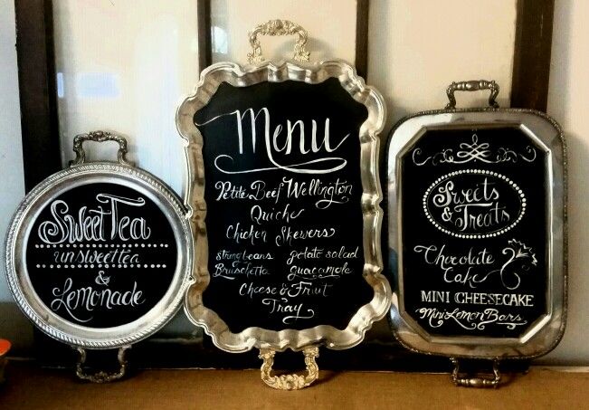 three framed chalkboard menus are sitting on a shelf