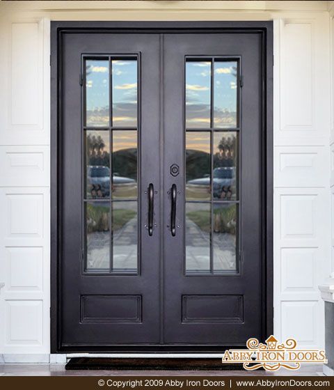 a black double door with two sidelights and glass panels on the front of a house