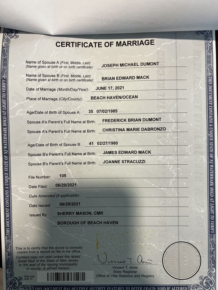 a marriage certificate is being held up in front of the camera