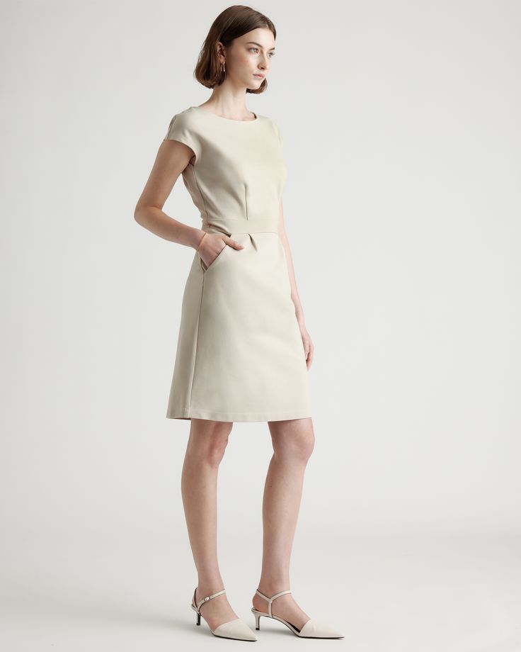 Ready to go for work or date night, this simple-yet-elegant cap sleeve dress is part of our best-selling ponte collection. You’ll feel like a boss thanks to the smooth, streamlined fit of our thick, stretchy knit fabric that’s as comfortable as it is alluring. And it looks great dressed up or down.  | Quince | Women's Ultra-Stretch Ponte Cap Sleeve Dress in Ecru, Size XS, Rayon Classic H-line Midi Dress For Work, Classic H-line Office Dresses, Seamed A-line Dress For Work, Fitted Minimalist Midi Dress, A-line Seamed Dress For Work, Chic Fitted Seamed Midi Dress, Minimalist Fitted Midi Dress, Sleek H-line Workwear Dresses, Seamed Knee-length Dress For Work