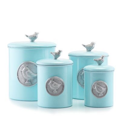 three blue canisters with birds on them