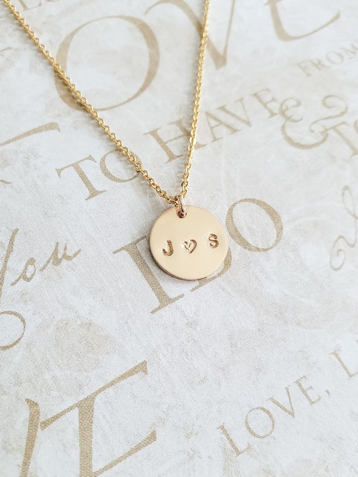 "Couples Initial Necklace - 14K Gold Filled - Mothers Gift - Name Necklace - Initial Necklace - Personalized Necklace - Gift for Her - 11mm * Dimensions: 11mm Diameter 14K Gold Filled Circle Disc Pendant * Necklace Chain Length: Available in 14in, 16in, or 18in ---------------------------------- HOW TO ORDER 1. Select the length that you would like from the drop down menu. * This item only comes in Font Type 3 (1.5mm)* This listing is for (1) necklace. Please feel free to let us know if you have 14k Gold Necklace For Valentine's Day, Valentine's Day Tarnish Resistant Necklace, Elegant Stamped Jewelry For Valentine's Day, Stamped Initial Pendant Necklaces For Anniversary, Stamped Initial Pendant Necklace For Anniversary, 14k Gold Charm Necklace For Anniversary, Stamped 14k Gold Rose Gold Jewelry, Elegant 14k Gold Hand Stamped Necklaces, Elegant Hand Stamped 14k Gold Jewelry