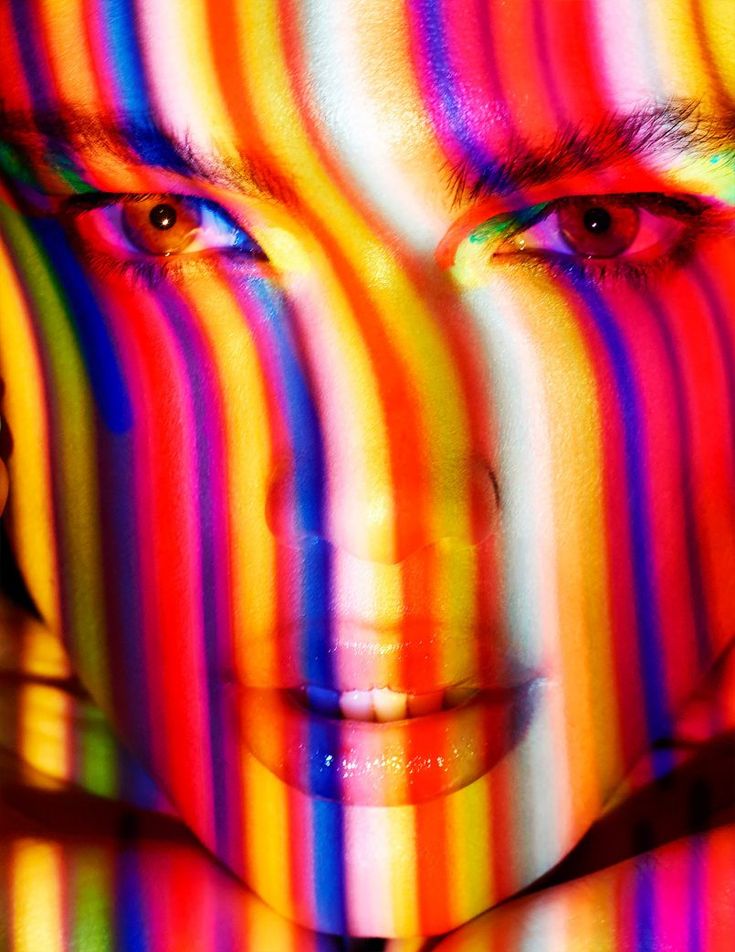 a woman's face with multicolored lines on her body and the eyes