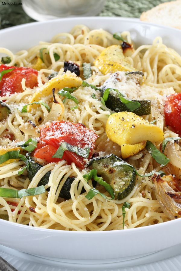 a white bowl filled with pasta and vegetables