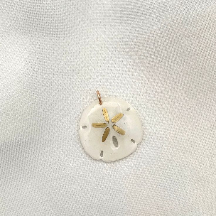 Legend has it that finding a sand dollar during a beach stroll is considered a lucky omen. So take a little bit of the beach and good luck with you wherever you go with our gorgeous Sand Dollar Charm. Real sand dollars are preserved and painted by hand in our MA studio sand dollars measure approximately 3/4 in to 1 inch. sterling silver or 14kt gold fill jump ring Preppy Jewelry, Sand Dollars, Sand Dollar, 14kt Gold, Good Luck, 1 Inch, The Beach, Charms, Sterling Silver