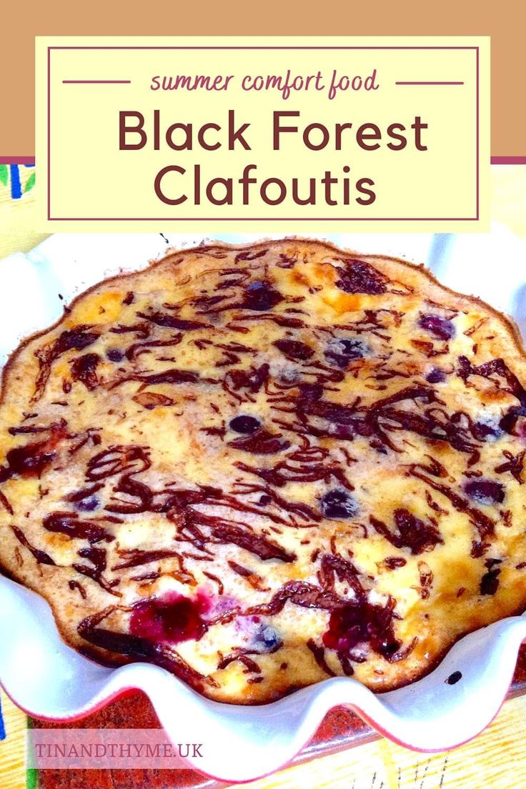 a close up of a pie on a plate with the words black forest clafoutis