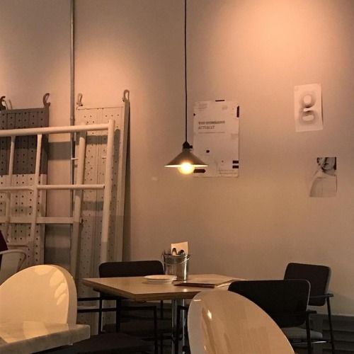 an empty restaurant with tables and chairs in the center, along with shelves on the wall