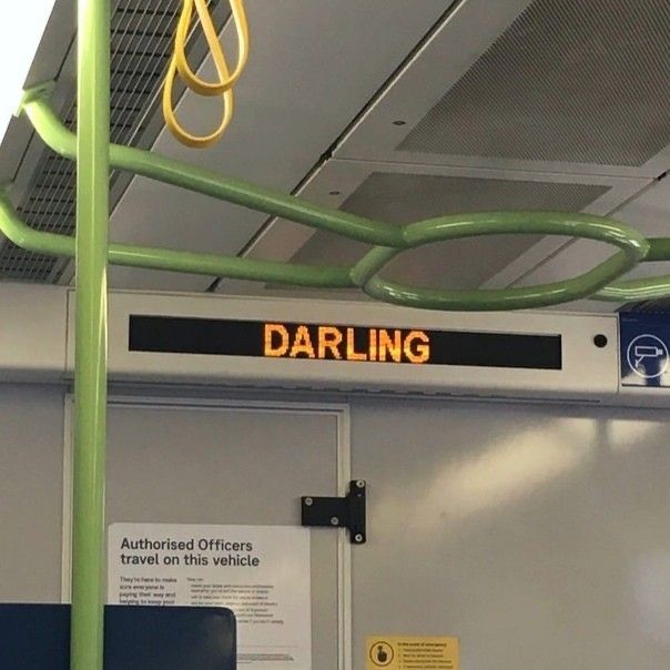 a sign that says darling on the side of a train car with wires hanging from it's ceiling