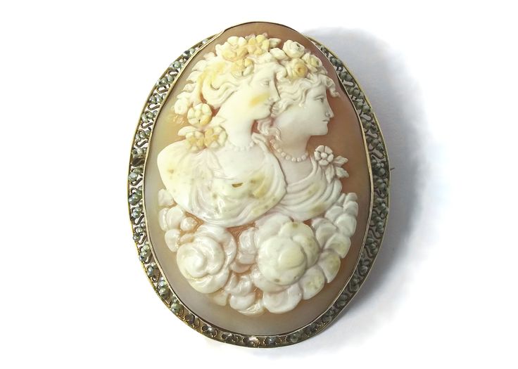 This unusual finely carved pendant and brooch are on sale for $1,296.00 reduced from $1,440.00. Item: Brooch/Pendant Circa: 1837 - 1901, probably The Romantic Period (1837-1860)  Cameo Material: Carnelian Shell Decorative Material: Natural Seed Pearls on border of tiny filigree hearts. Metal: 14 Kt Yellow Gold, Marked Size (Approximate): Oval Bezel 2.1875 inches long x 1.75 inch; Carnelian shell Cameo: 2.125 inches x 1.5 inches Weight: 21.93 grams Condition: Overall condition is excellent with n Antique Carved Brooches For Weddings, Ornate Oval Carved Brooches, Ornate Carved Oval Brooches, Antique Medallion Brooch For Wedding, Carved Oval Brooch For Formal Occasions, Carved Oval Brooch For Formal Wear, Elegant Medallion Brooch For Collectors, Carved Yellow Gold Brooches For Wedding, Carved Oval Brooches For Formal Wear