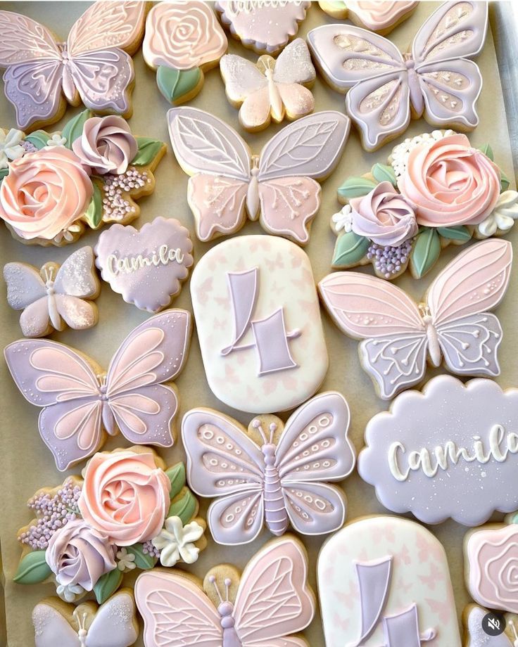 decorated cookies in the shape of flowers and butterflies