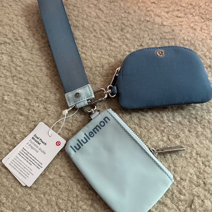 there is a blue purse with a name tag on it and a keychain