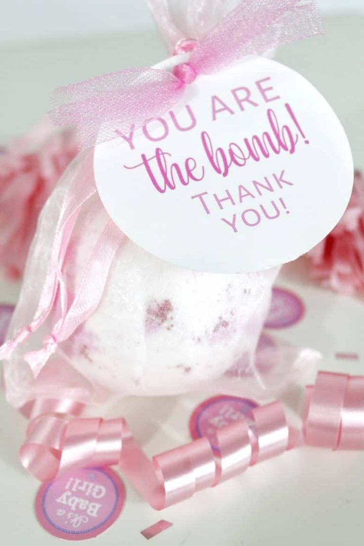 a pink and white bath bomb with a thank you tag on it