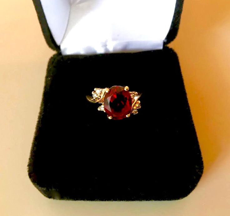 14K YELLOW GOLD, Vintage ring of solid gold, set with an oval facet garnet (3.20ct) accented with six 0.09ctw of fine full cut round brilliant (SI, H-I) diamonds. Item: Garnet and Diamond Ring Gemstones: Garnet (natural, oval facet); Diamonds (natural, full cut round brilliant) Approx. Measurement or Weight of Gem Stones: Garnet: 10.0mm x 8.15mm x 4.9mm (3.20ct); Diamonds: 6 @ 1.5mm (0.09ctw) Color: H-I Clarity: SI Mounting metal: 14K Yellow Gold Approx. Size or length: Size 5.5, band is 1.9mm w Hallmarked Oval Diamond Gemstones, Oval Ruby Ring With Diamond Accents For Promise, Elegant Pear-shaped Yellow Gold Birthstone Ring, Luxury Oval Birthstone Gemstones, Oval Diamond Ring Gift, Gold Marquise-cut Ruby Jewelry, Yellow Gold Diamond Ring With Oval Cabochon, Gold Ruby Marquise Cut Jewelry, Gold Marquise Cut Ruby Jewelry