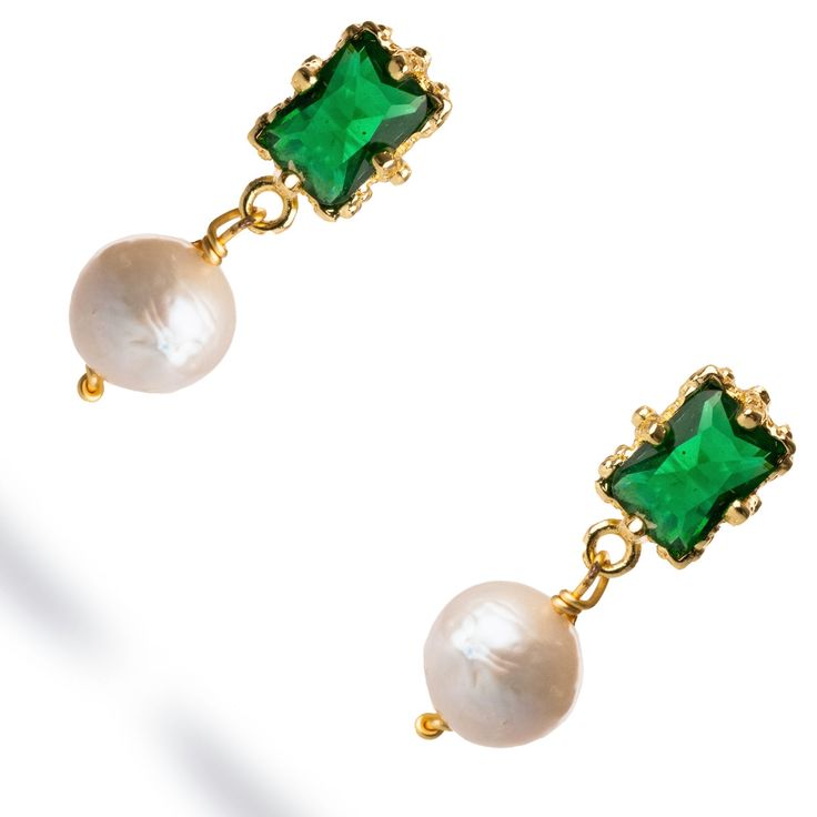 Minimalist Emerald & Pearl Statement Earrings, crafted in 18k gold plating. These chic earrings feature a regal emerald stone set in a sleek gold frame, with a delicate pearl dangling below. The combination of the vibrant emerald and classic pearl creates a sophisticated yet minimalist design, perfect for adding a touch of refinement to any look. Ideal for both formal occasions and elevating everyday style, these earrings are the epitome of understated luxury. Details 18k gold plated on brass Emerald and Pearl Avoid contact with chemicals, makeup, parfume. Do not use dips or abrasive cleaners on earrings. To clean and brighten it up your earrings, wipe them gently with jewelry polishing cloth. Luxury Green Jewelry With Pearl Drop, Classic Green Pearl Earrings As Gift, Classic Green Pearl Earrings For Gift, Fine Jewelry Green Pearl Earrings For Gift, Timeless Green Earrings As A Gift, Timeless Green Earrings For Gift, Elegant Single Emerald Earring, Emerald Earrings With Pearl Drop For Gift, Pearl Statement Earrings