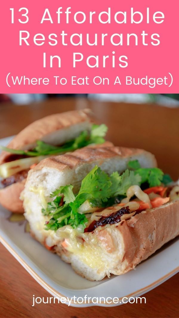 a white plate topped with a sandwich on top of a wooden table and text overlay reads 13 affordable restaurants in paris where to eat on a budget